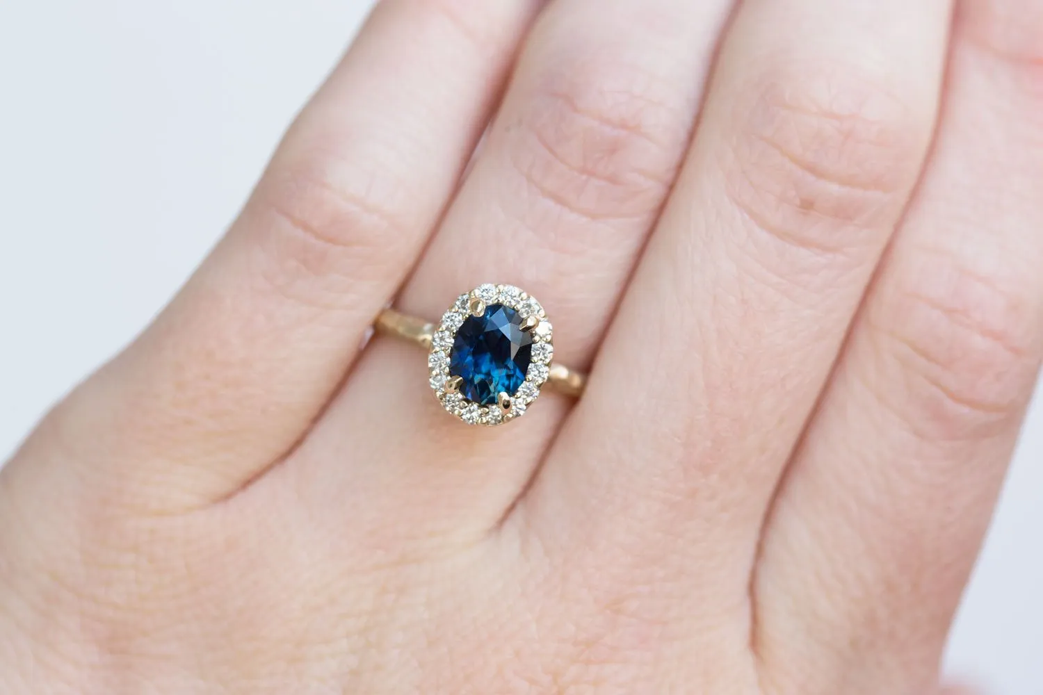 1.32ct Royal Blue Oval Sapphire Halo Ring - Evergreen Carved Band in a Satin Finish 14k Yellow Gold